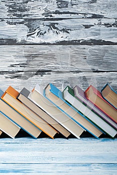 Stack of colorful books. Education background. Back to school. Book, hardback colorful books on wooden table. Education