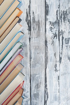 Stack of colorful books. Education background. Back to school. Book, hardback colorful books on wooden table. Education