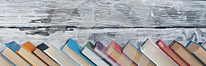 Stack of colorful books. Education background. Back to school. Book, hardback colorful books on wooden table. Education business