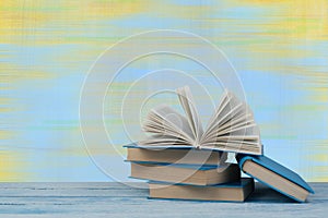 Stack of colorful books. Education background. Back to school. Book, hardback colorful books on wooden table. Education business