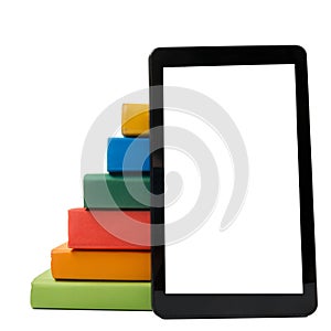 Stack of colorful books and electronic book reader. Electronic library concept. Back to school. Copy space