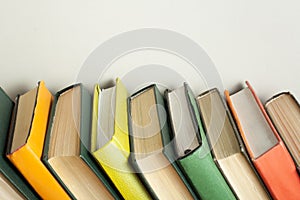 Stack of colorful books on wooden desk. Copy space for text. Back to school. Education background