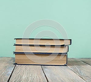 Stack of colorful books on wooden desk, free copy space. Back to school. Education background