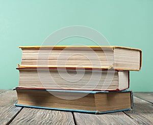 Stack of colorful books on wooden desk, free copy space. Back to school. Education background