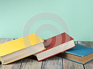 Stack of colorful books on wooden desk, free copy space. Back to school. Education background