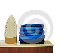 Stack of colorful clean towels  on white background. Ironing clothes on ironing board. Stack of clean towels on table. Colored tow