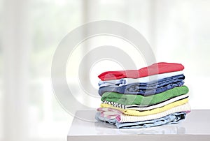 Stack of colorful clothes on table empty copy space,cotton clothing pile