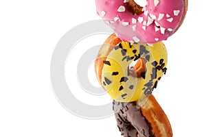 Stack of colorful donuts isolated on white background