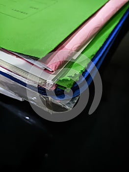 Stack of colorful file folders with papers