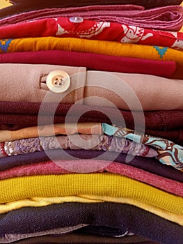 A stack of colorful ironed and folded clothes