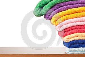 Stack of colorful microfiber towels toppling photo