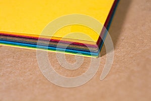 Stack of colorful paper. Blurring background. The corners of sheets of paper close-up. Back to school. Bright natural background