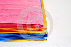 stack of colorful paper napkins on a white background