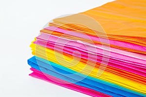 stack of colorful paper napkins on a white background