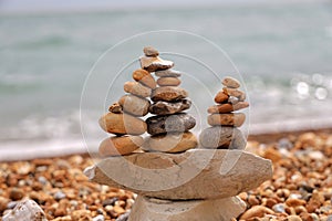 Stack of colorful pebbles stone against  sea wave background.