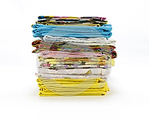 A stack of colorful pillowcases over a white background