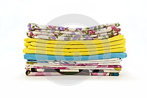 A stack of colorful pillowcases over a white background