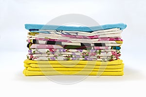 A stack of colorful pillowcases over a white background
