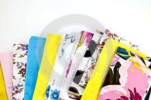 A stack of colorful pillowcases over a white background