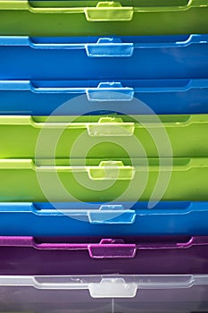 stack of colorful plastic boxes, closeup shot, abstract background in stripes