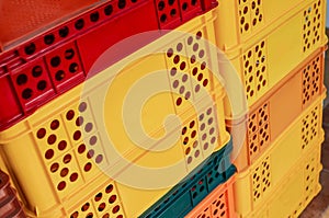 Stack of colorful plastic crates or boxes for transporting bakery and food products.