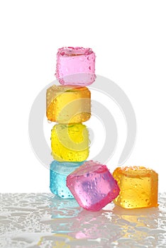 Stack of colorful plastic ice cubes with water