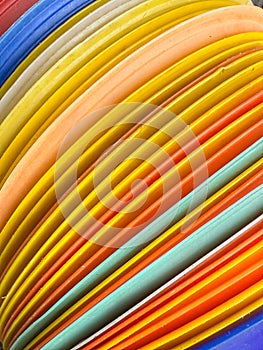 A stack of colorful plastic plates with a rainbow pattern