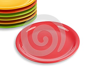 Stack of colorful plates with empty red one