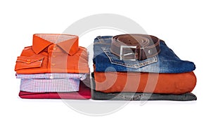Stack of colorful shirts, sweaters and jeans