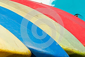 Stack of colorful sport kayaks