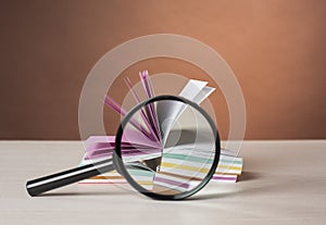 Stack of colorful stickers and magnifying glass