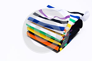 Stack of colorful striped socks over white background