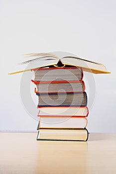 A stack of colorful thick books on a table