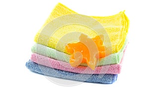 A stack of colorful towels and soap in the shape of a star-shaped folded square