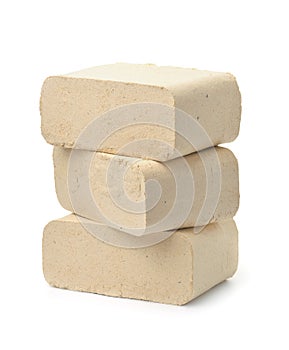 Stack of compressed sawdust fuel briquettes photo