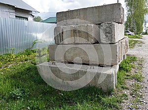 Stack of concrete blocks, construction site against a blue sky