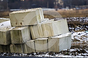 Stack of concrete blocks for foundation on construction site. Ferroconcrete reinforced with metal blocks