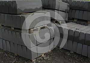 Stack of concrete curbstone. Construction process