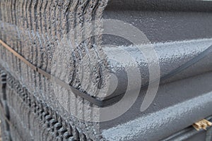 Stack of concrete roof tile (gray color) at construction site