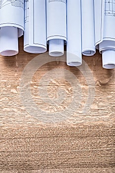 Stack of construction plans on wooden oaken board