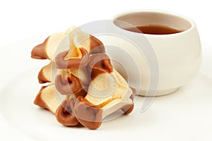 Stack of cookies and cup of tea on plate