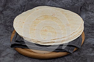 Stack of corn tortillas on dark background. Mexican food