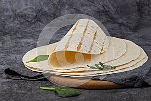 Stack of corn tortillas on dark background. Mexican food