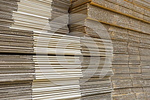 stack of corrugated cardboard boxes. egde view of flattened boxes.