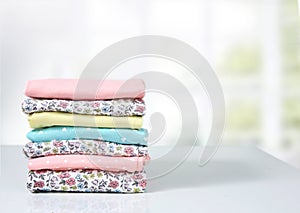 Stack of cotton folded clothes empty space background