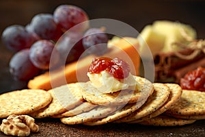 Stack of crackers with apple chutney and other snacks