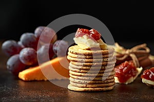 Stack of crackers with apple chutney and other snacks