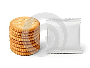Stack of crackers beside blank packaging isolated on white background
