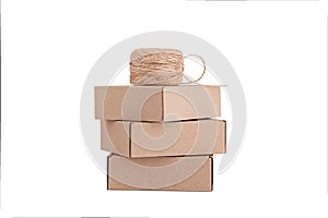 Stack of craft paper boxes and coil of rope isolated on white