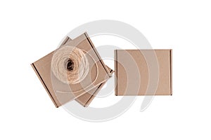 Stack of craft paper boxes and coil of rope isolated on white